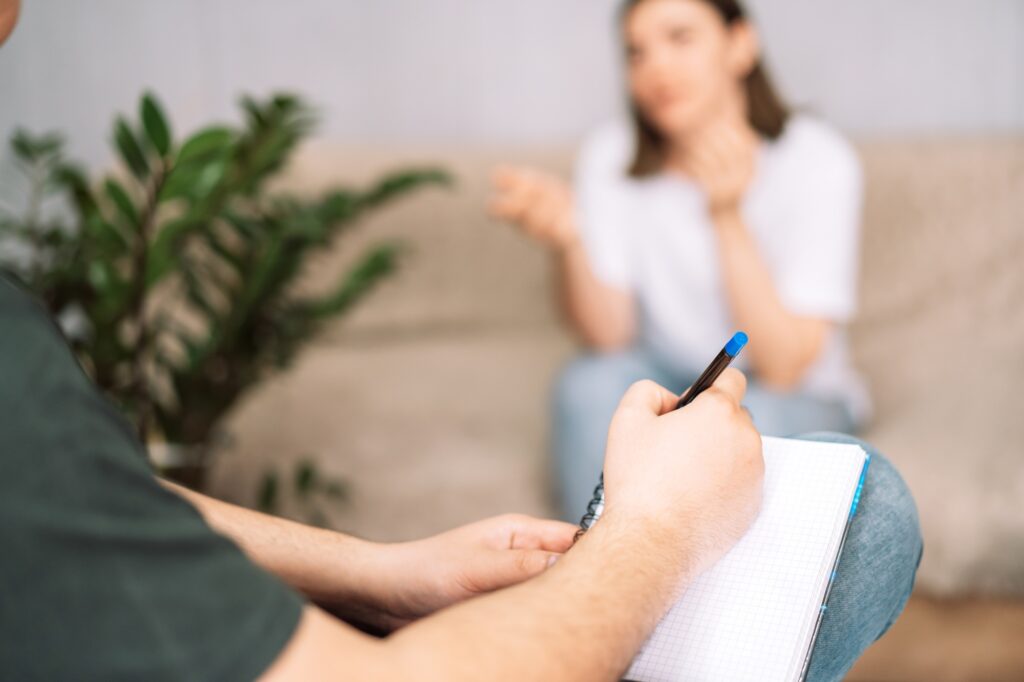 The girl tells the psychologist, and the psychologist writes in a notebook